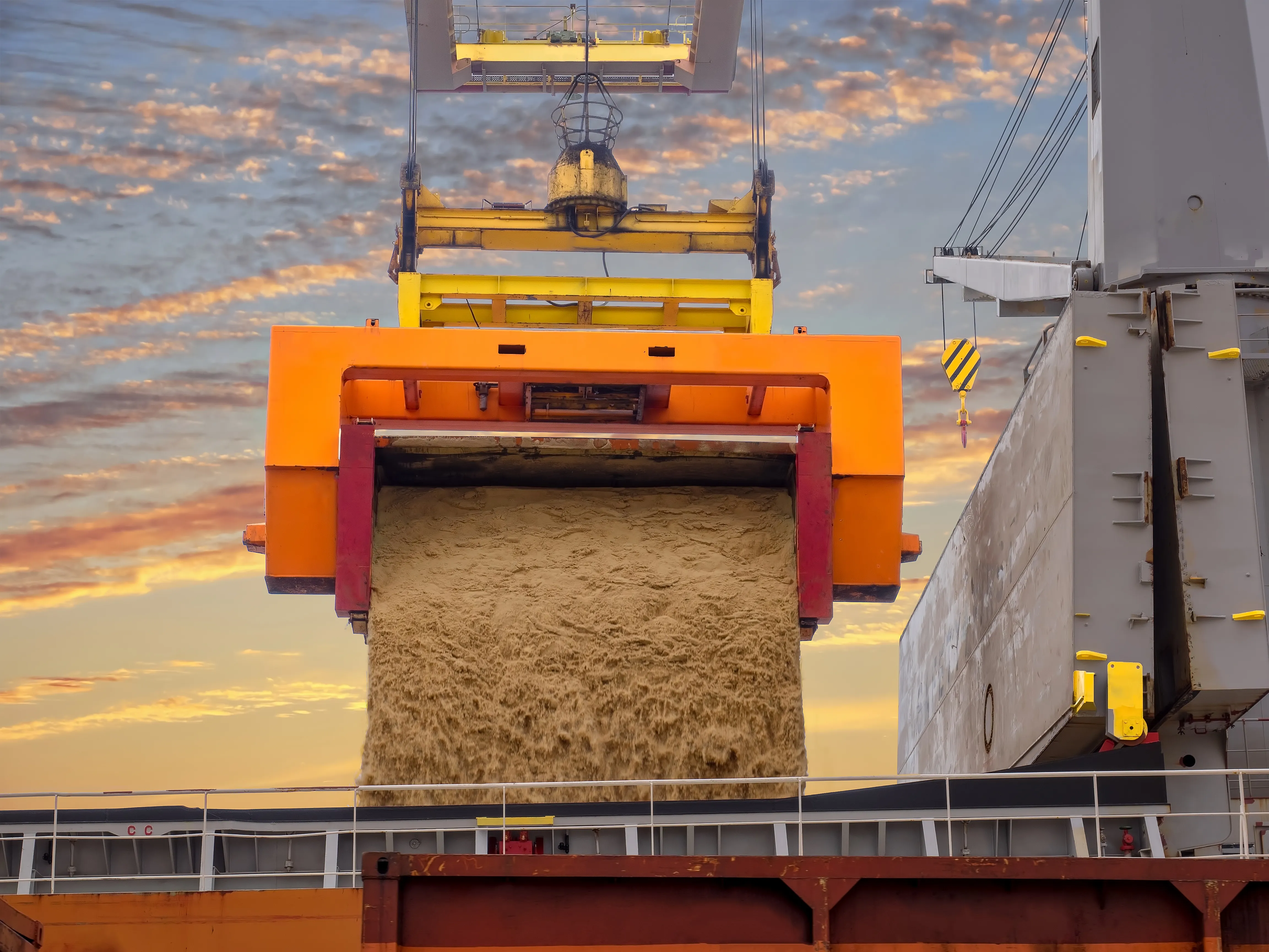 Bulk sugar pouring into ship hold